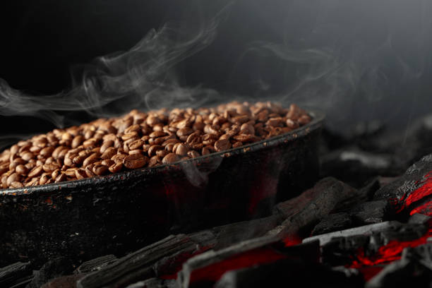 Granos de café tostado humeantes